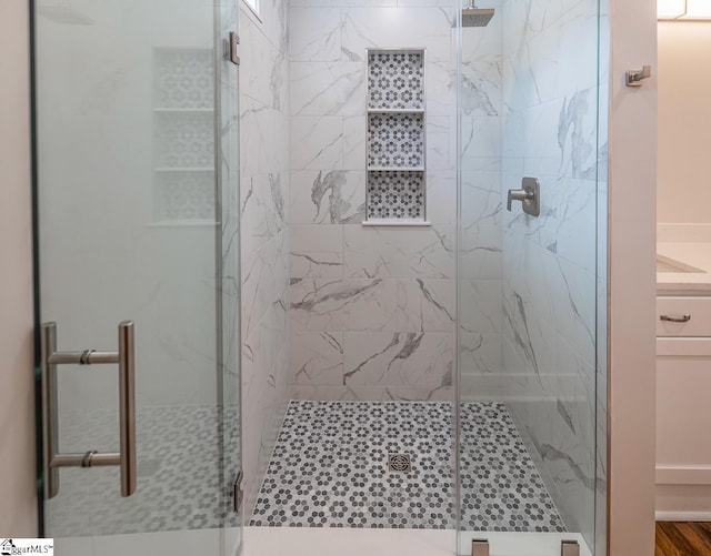 bathroom featuring vanity and a shower with shower door