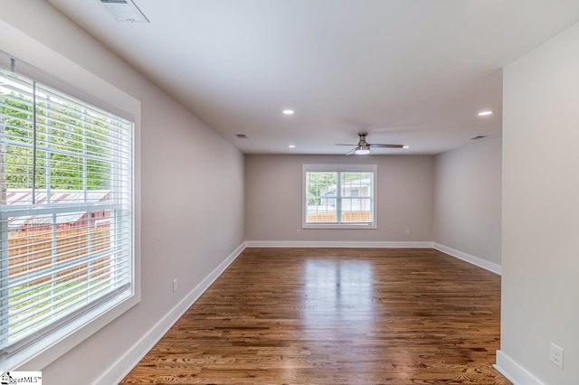 spare room featuring ceiling fan and dark hardwood / wood-style floors