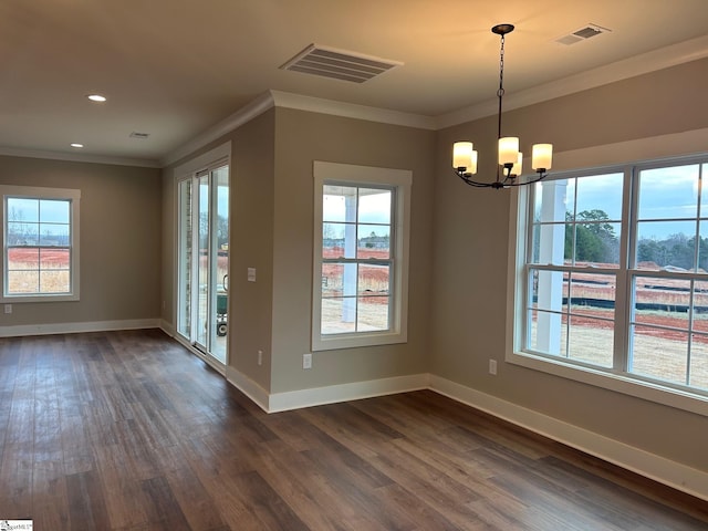 unfurnished dining area with crown molding, a healthy amount of sunlight, dark hardwood / wood-style floors, and a notable chandelier