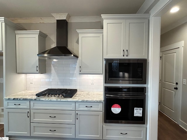 kitchen featuring white cabinets, wall chimney range hood, and stainless steel appliances