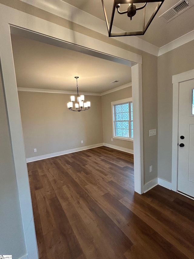 interior space featuring a notable chandelier, ornamental molding, and dark hardwood / wood-style floors