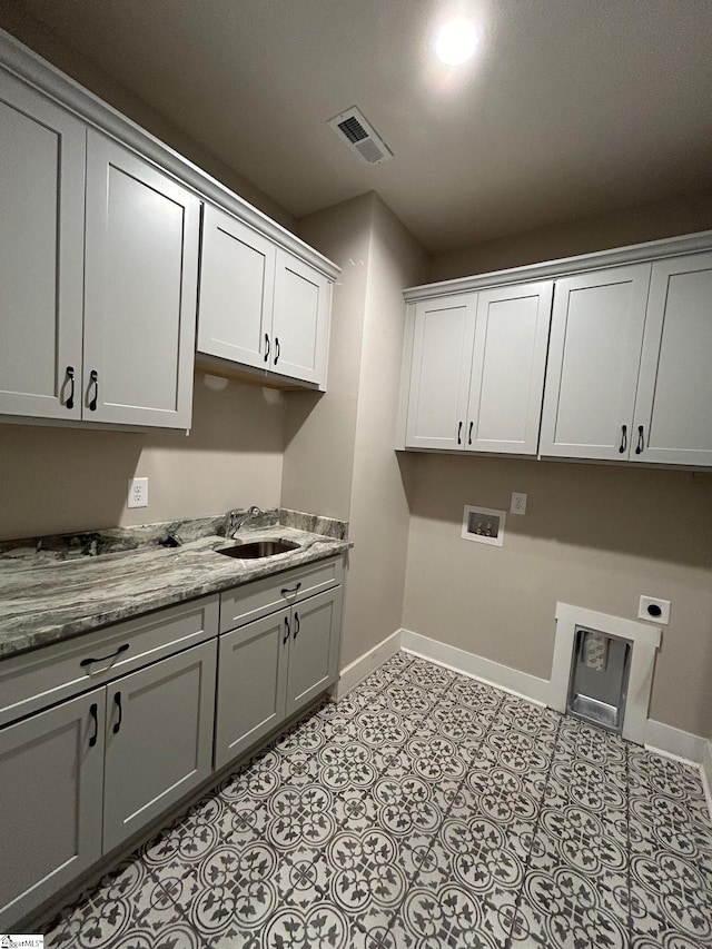 laundry area featuring sink, washer hookup, light tile patterned floors, hookup for an electric dryer, and cabinets