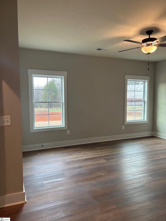 unfurnished room with hardwood / wood-style flooring and ceiling fan