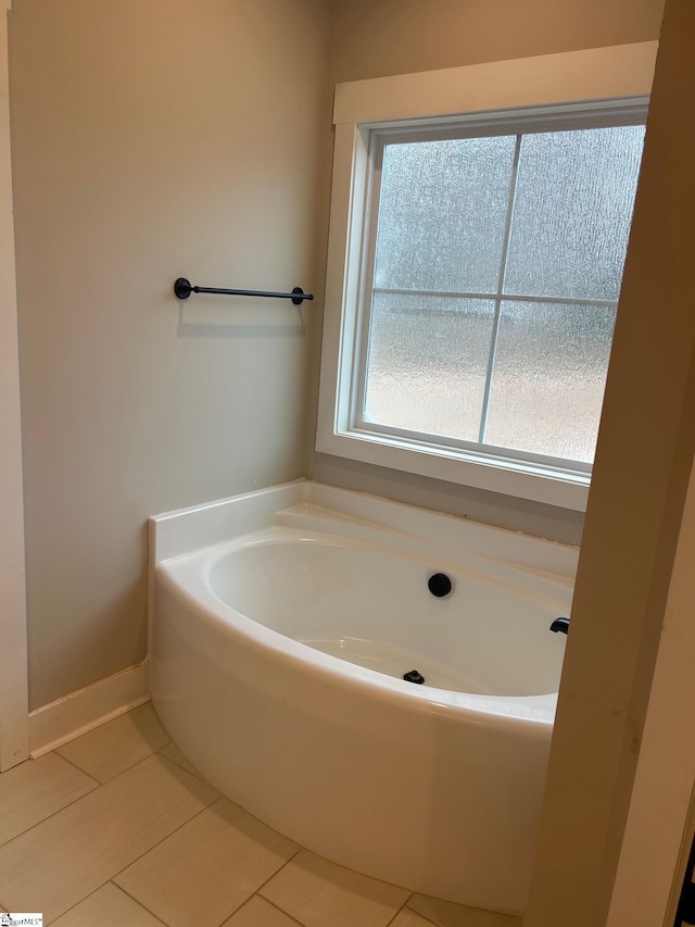 bathroom with a tub and tile patterned floors