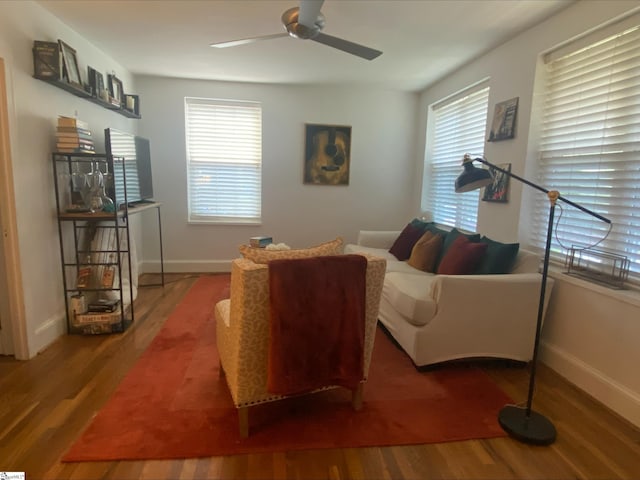 living room featuring hardwood / wood-style floors and ceiling fan