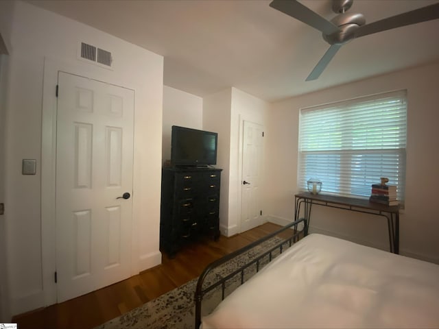 bedroom with dark wood-type flooring and ceiling fan