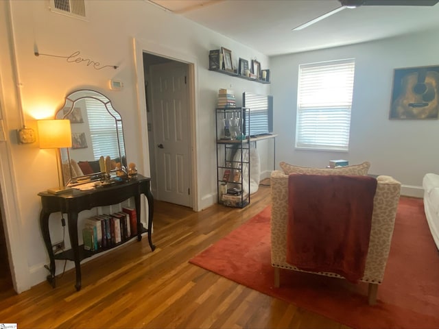 living room featuring ceiling fan and wood-type flooring