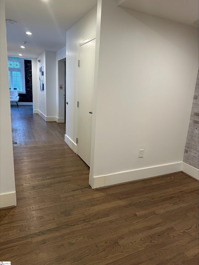 hall with dark wood-type flooring