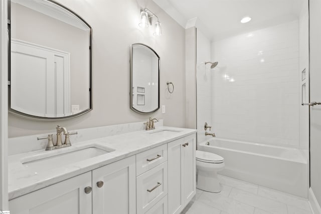 full bathroom featuring vanity, tiled shower / bath, and toilet