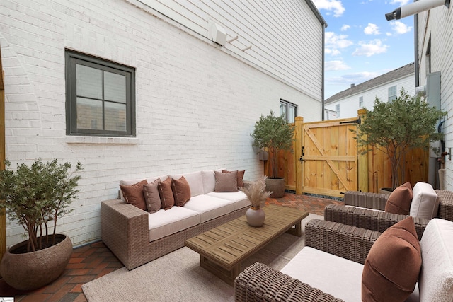 wooden terrace with an outdoor hangout area and a patio area