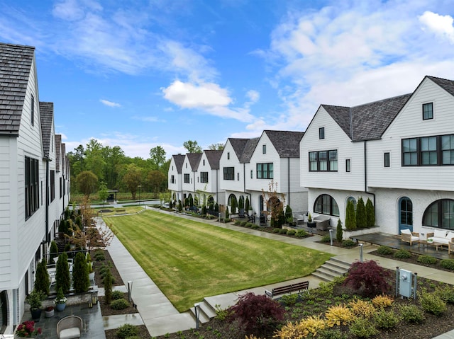 surrounding community featuring a patio area and a lawn