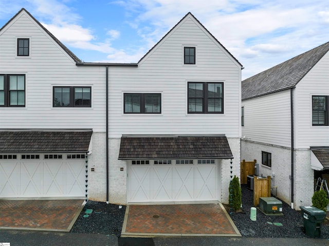 back of property with a garage