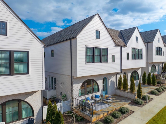 back of house with an outdoor hangout area and a patio area