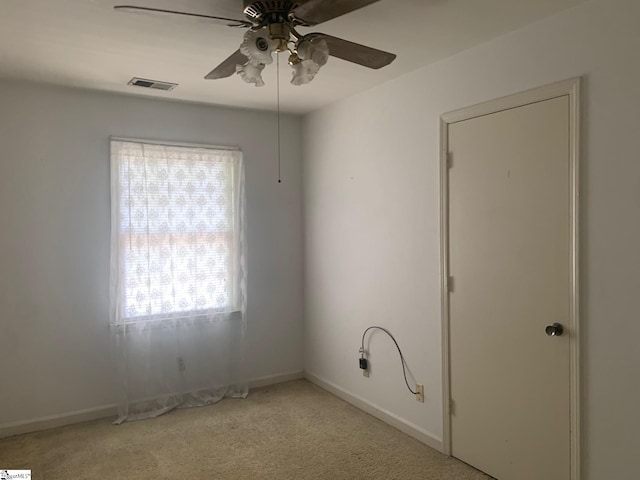 unfurnished room with a healthy amount of sunlight, carpet flooring, and ceiling fan