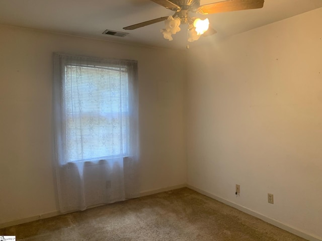 unfurnished room with ceiling fan and carpet floors