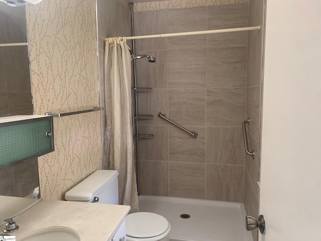 bathroom with walk in shower, toilet, and vanity