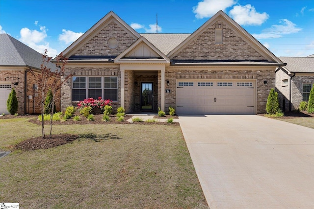 craftsman-style house featuring a front lawn and a garage