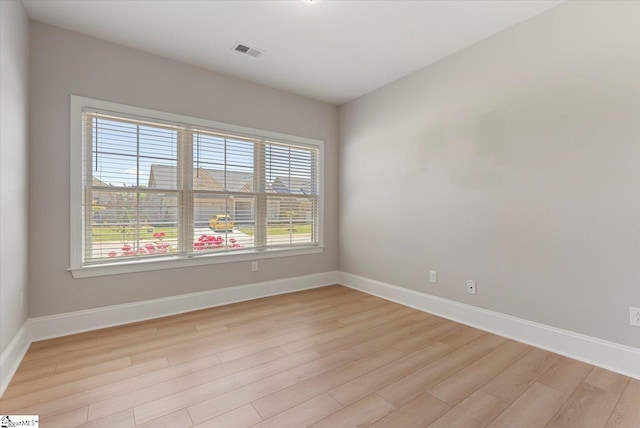 spare room featuring plenty of natural light and light wood-type flooring