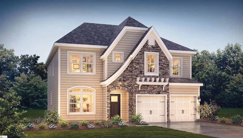 view of front facade featuring a front yard and a garage