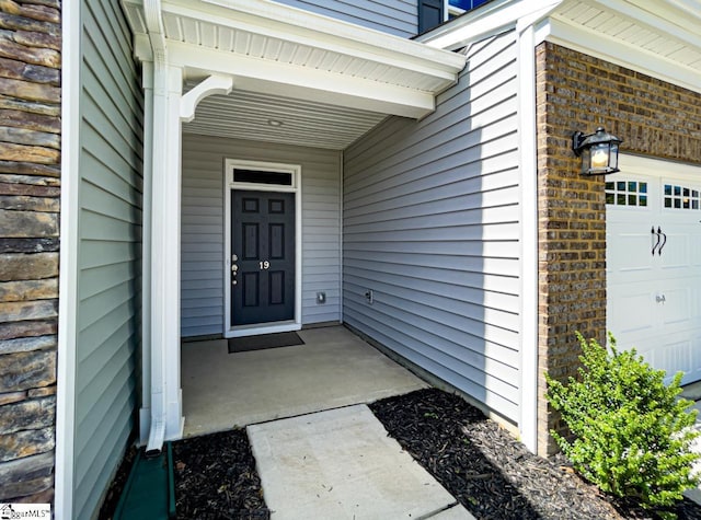 doorway to property featuring a garage