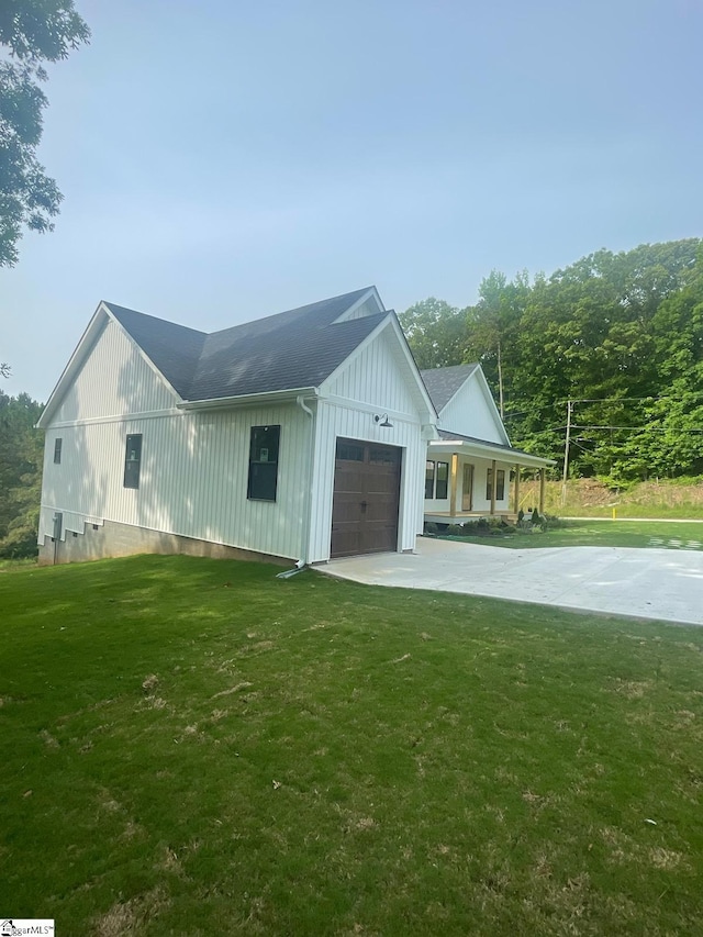 view of property exterior with a yard and a garage