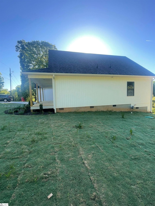 back of house with a lawn