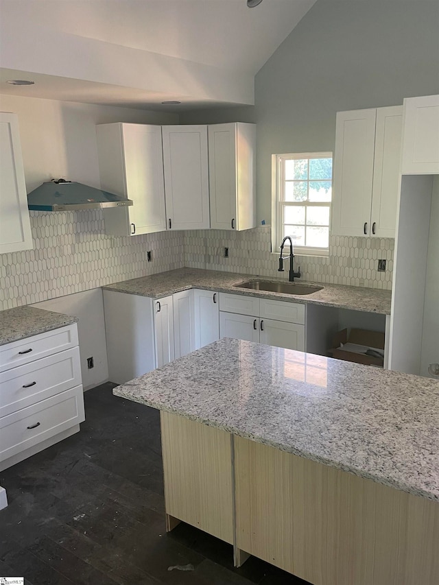 kitchen featuring backsplash, sink, and light stone countertops