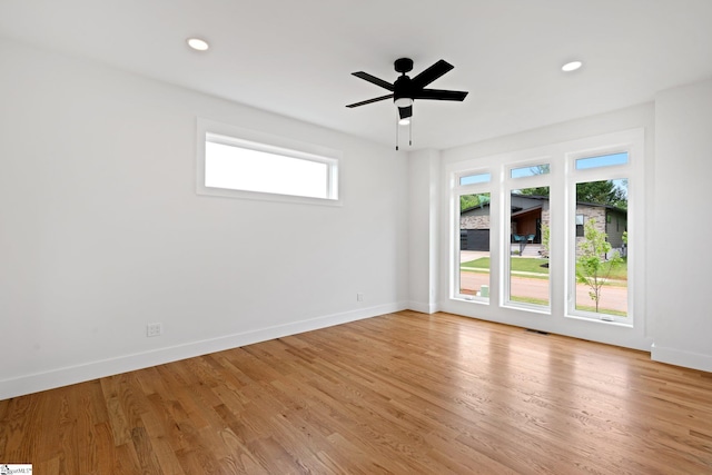 empty room with ceiling fan and light wood-type flooring