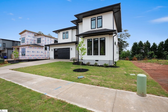 view of front facade with a garage and a front lawn