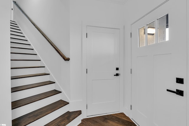 entryway featuring dark wood-style floors and stairs