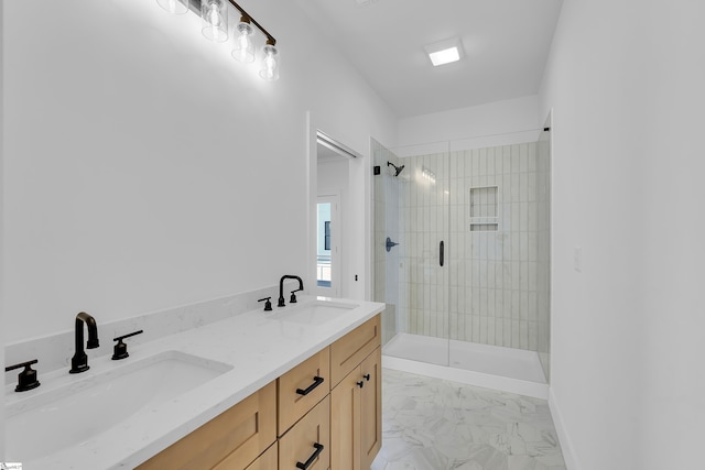 bathroom with a shower stall, double vanity, marble finish floor, and a sink