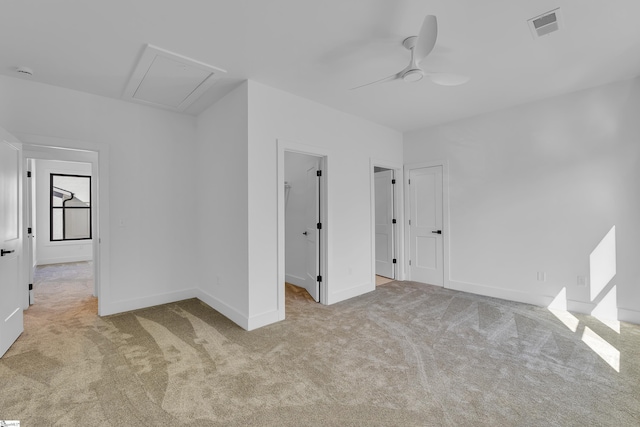 empty room featuring a ceiling fan, carpet, visible vents, and baseboards