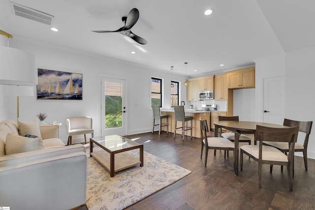 living room with visible vents, ornamental molding, a ceiling fan, recessed lighting, and dark wood-style flooring