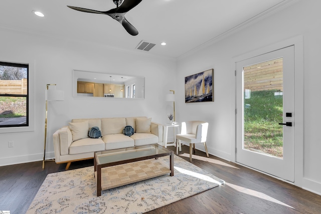 living area with visible vents, baseboards, ornamental molding, recessed lighting, and wood finished floors