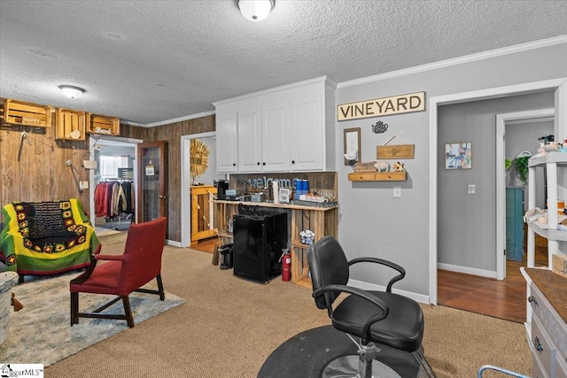 home office with light colored carpet, a textured ceiling, and crown molding