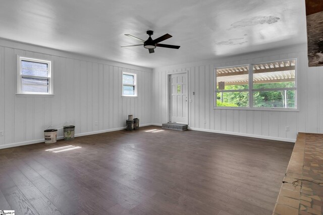 unfurnished living room with ceiling fan and dark hardwood / wood-style floors