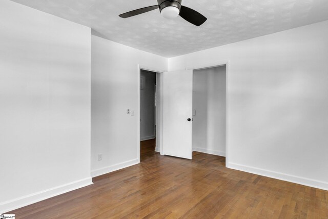 interior space with ceiling fan and dark hardwood / wood-style floors