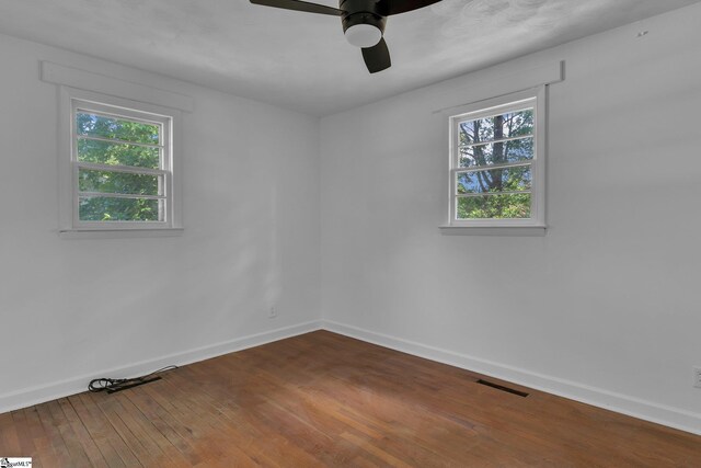 empty room featuring hardwood / wood-style flooring and ceiling fan