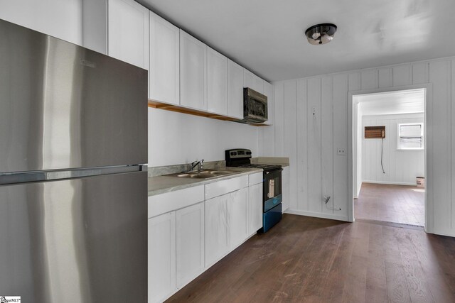 kitchen featuring stainless steel appliances, dark hardwood / wood-style flooring, white cabinets, and sink