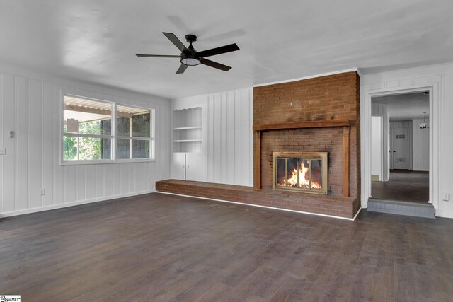 unfurnished living room with built in shelves, ceiling fan, dark hardwood / wood-style floors, and a fireplace