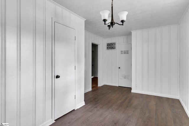 interior space with a chandelier and dark hardwood / wood-style floors