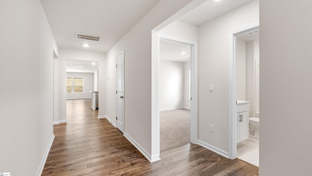 corridor with dark hardwood / wood-style flooring