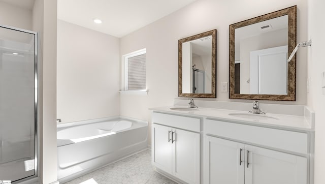 bathroom with tile patterned floors, vanity, and separate shower and tub