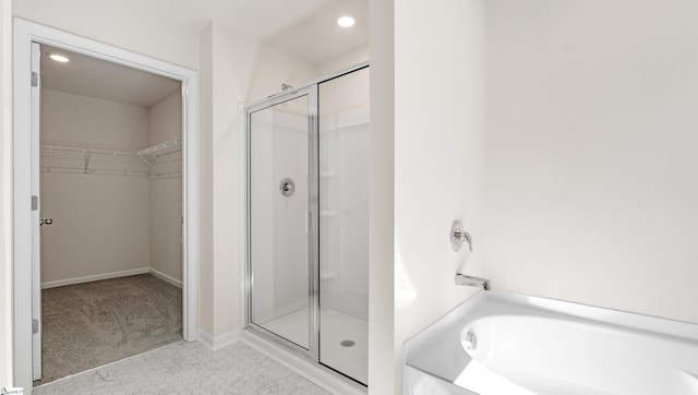 bathroom with tile patterned flooring and separate shower and tub