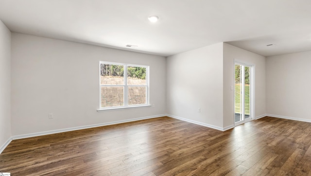 unfurnished room featuring dark hardwood / wood-style floors