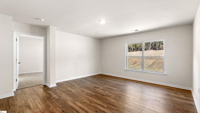 unfurnished room featuring dark hardwood / wood-style flooring