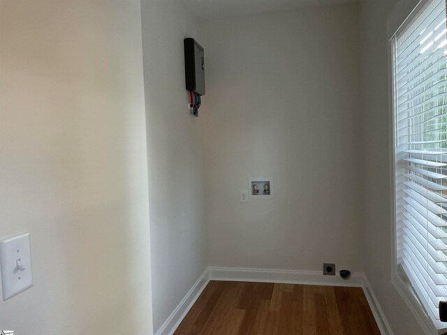 clothes washing area featuring hardwood / wood-style floors, electric dryer hookup, and hookup for a washing machine