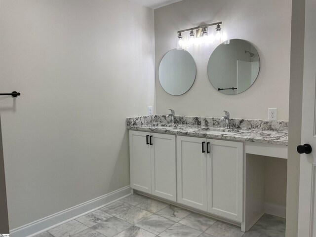 bathroom with vanity with extensive cabinet space, tile floors, and double sink