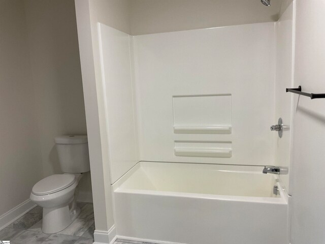 bathroom featuring tile flooring, tub / shower combination, and toilet