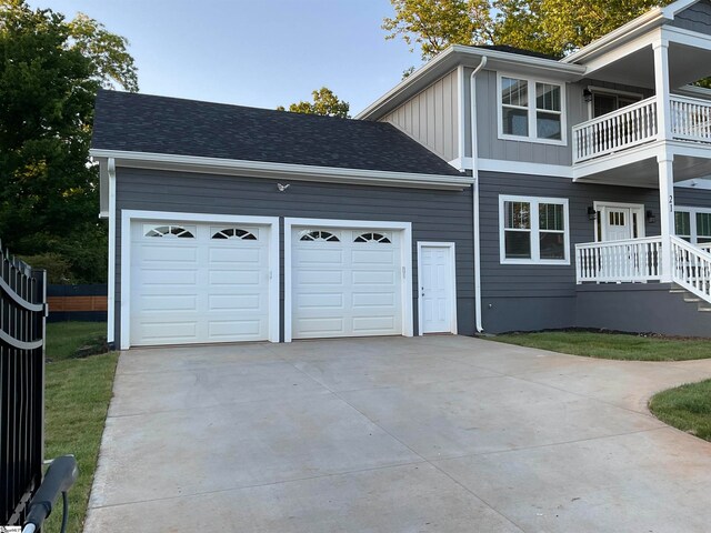 view of property exterior with a balcony and a garage